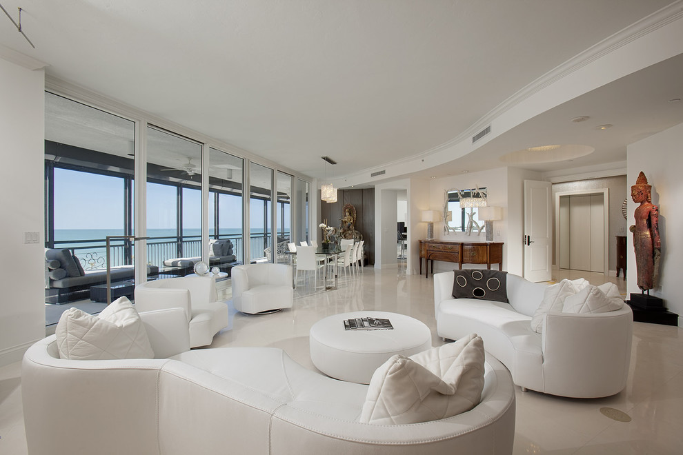 This is an example of an expansive contemporary living room in Miami with white walls.