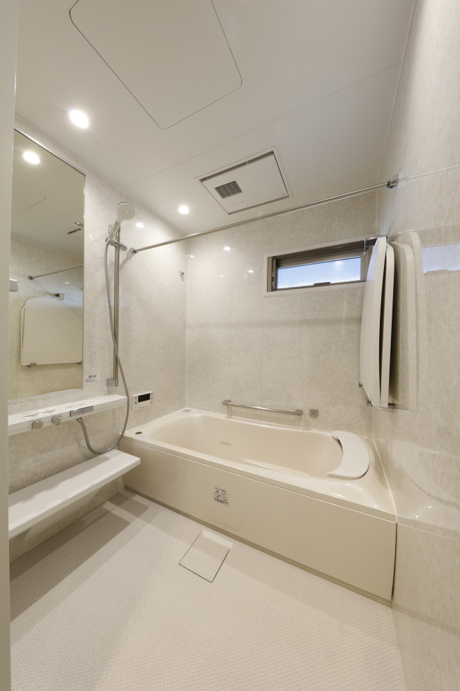 Photo of a small contemporary grey and cream ensuite wet room bathroom in Other with a corner bath, grey tiles, grey walls, beige floors and an open shower.