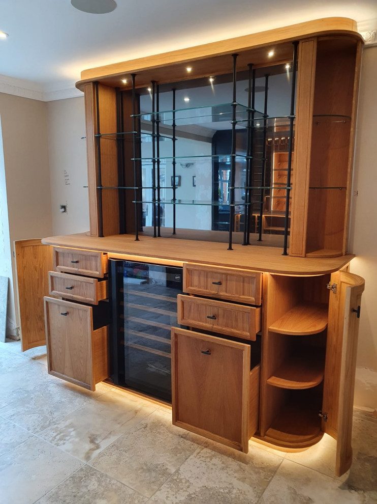 Mid-sized traditional wine cellar in West Midlands with display racks.