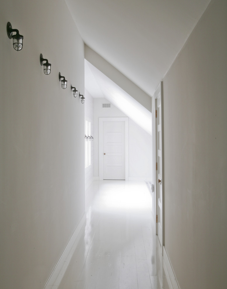 Inspiration for a beach style hallway in New York with white walls.