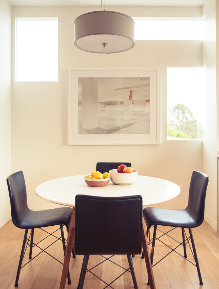 Design ideas for a contemporary dining room in Los Angeles with white walls and medium hardwood floors.