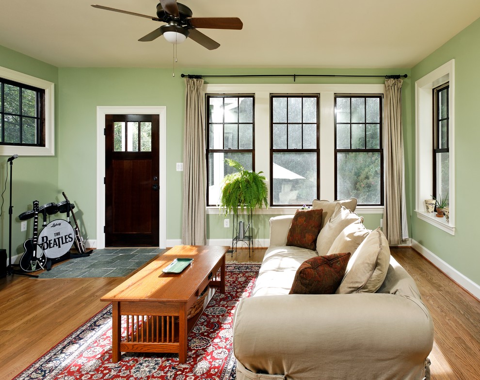 Inspiration for a mid-sized mediterranean enclosed family room in DC Metro with green walls and medium hardwood floors.