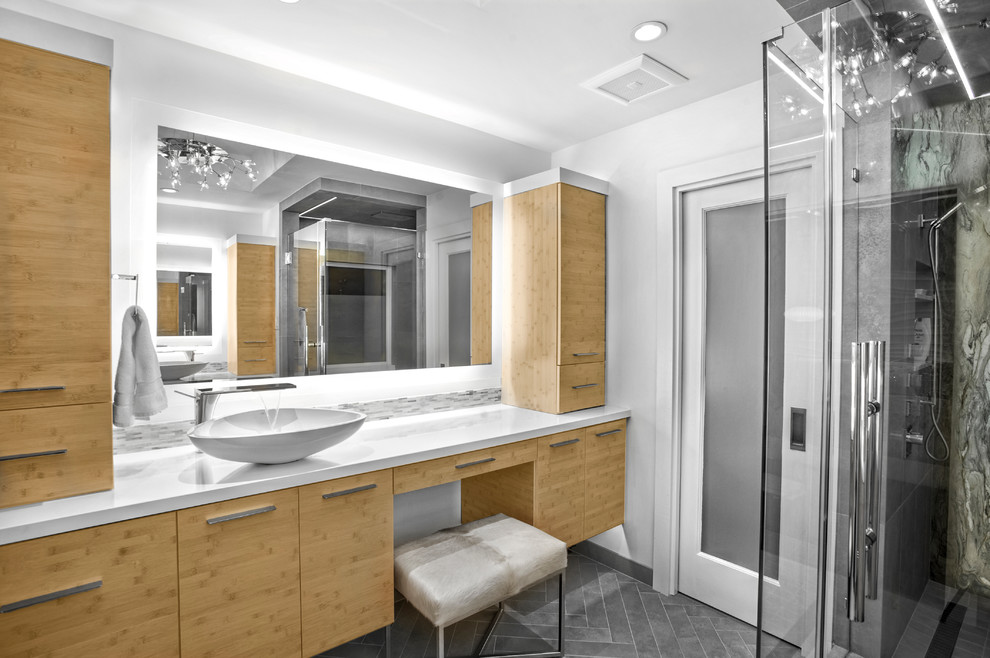 This is an example of a mid-sized midcentury master bathroom in Houston with flat-panel cabinets, medium wood cabinets, a freestanding tub, an alcove shower, gray tile, porcelain tile, white walls, porcelain floors, a vessel sink, quartzite benchtops, grey floor and a hinged shower door.