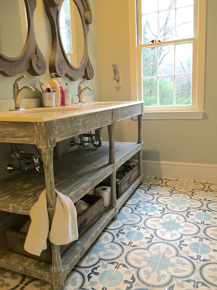 Mid-sized country master bathroom in New York with open cabinets, distressed cabinets, blue tile, gray tile, white tile, cement tile, grey walls, concrete floors, marble benchtops and an undermount sink.