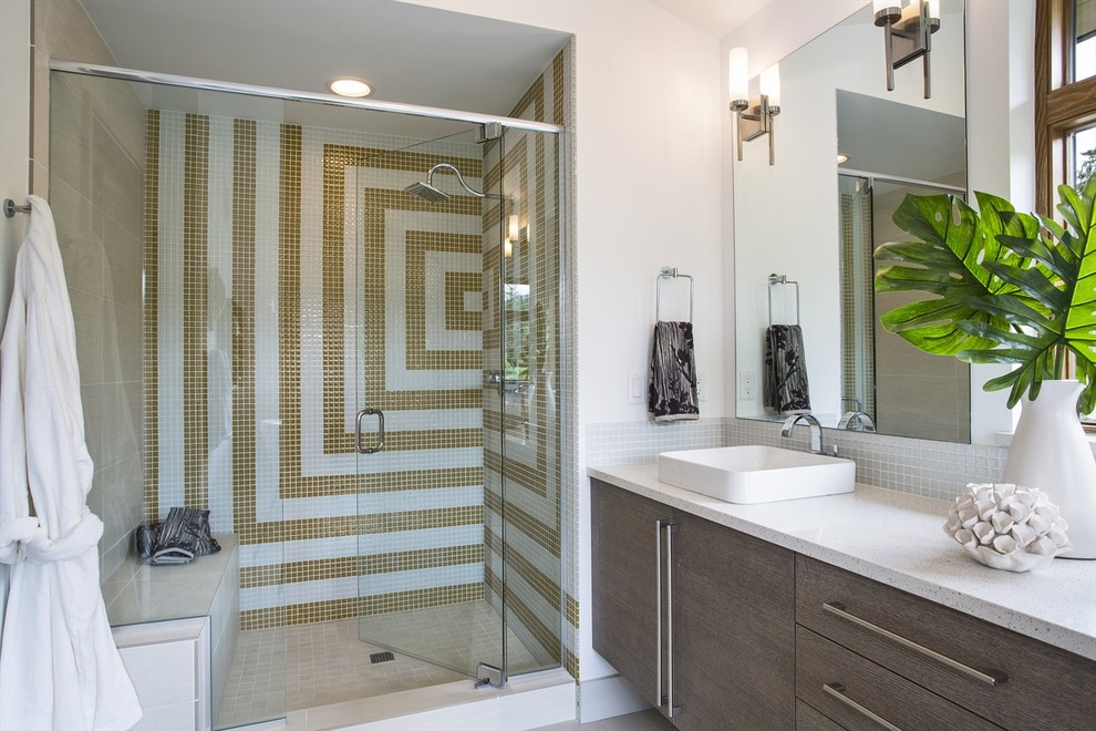 Photo of a contemporary bathroom in Seattle with a vessel sink, flat-panel cabinets, medium wood cabinets, an alcove shower, multi-coloured tile and mosaic tile.