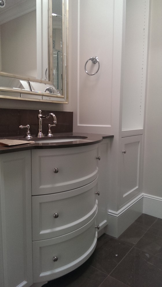 Mid-sized traditional master bathroom in Boston with shaker cabinets, white cabinets, a claw-foot tub, a corner shower, beige walls, cement tiles, an undermount sink, brown floor and a hinged shower door.