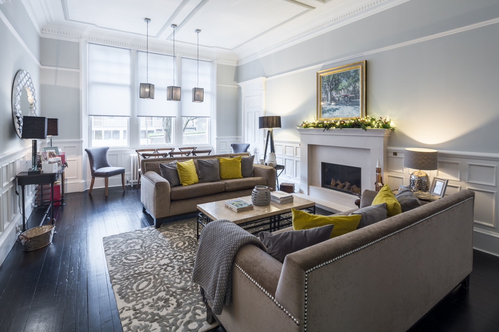 Inspiration for a mid-sized transitional formal open concept living room in Glasgow with grey walls, painted wood floors, a standard fireplace and black floor.