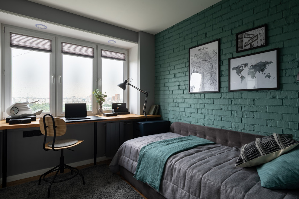 Small teen’s room for boys in Moscow with green walls, medium hardwood flooring and brick walls.