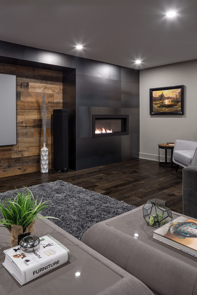 Photo of a contemporary basement in Ottawa with dark hardwood floors, a metal fireplace surround and brown floor.