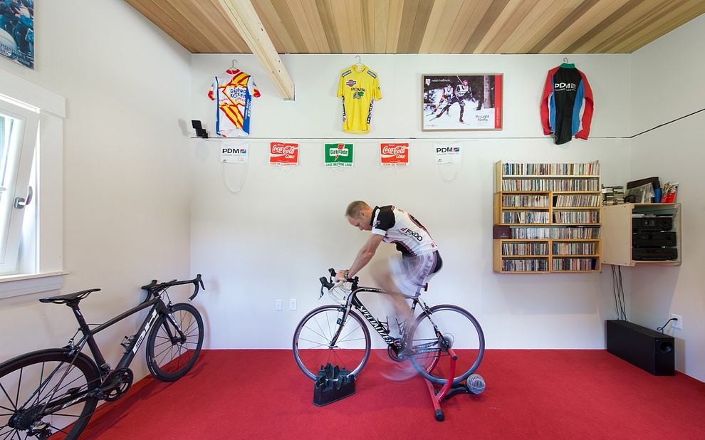 Example of a mid-sized farmhouse red floor multiuse home gym design in Boston with white walls