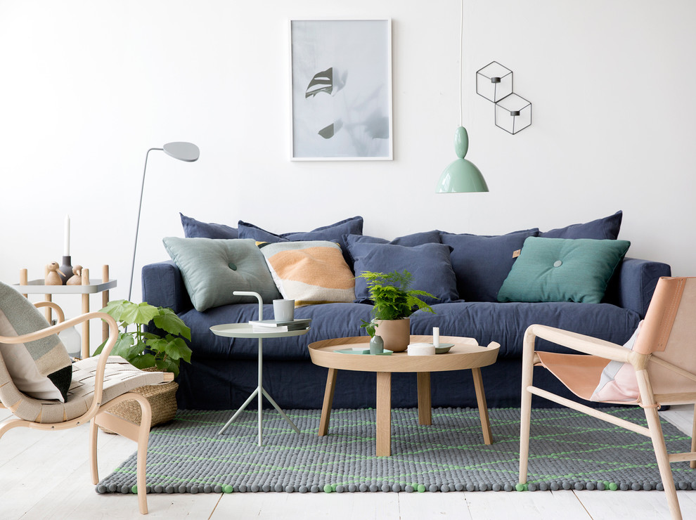 This is an example of a scandinavian formal open concept living room in Gothenburg with white walls, painted wood floors, no fireplace and no tv.