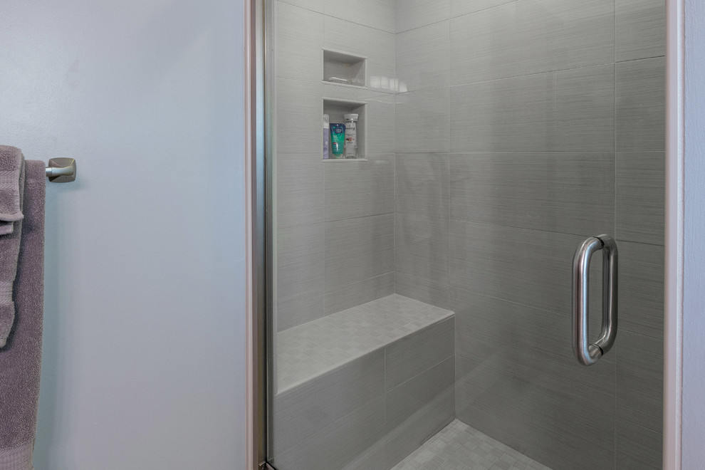 Inspiration for a large transitional master gray tile and subway tile alcove shower remodel with shaker cabinets, dark wood cabinets, a two-piece toilet, blue walls, an undermount sink and granite countertops