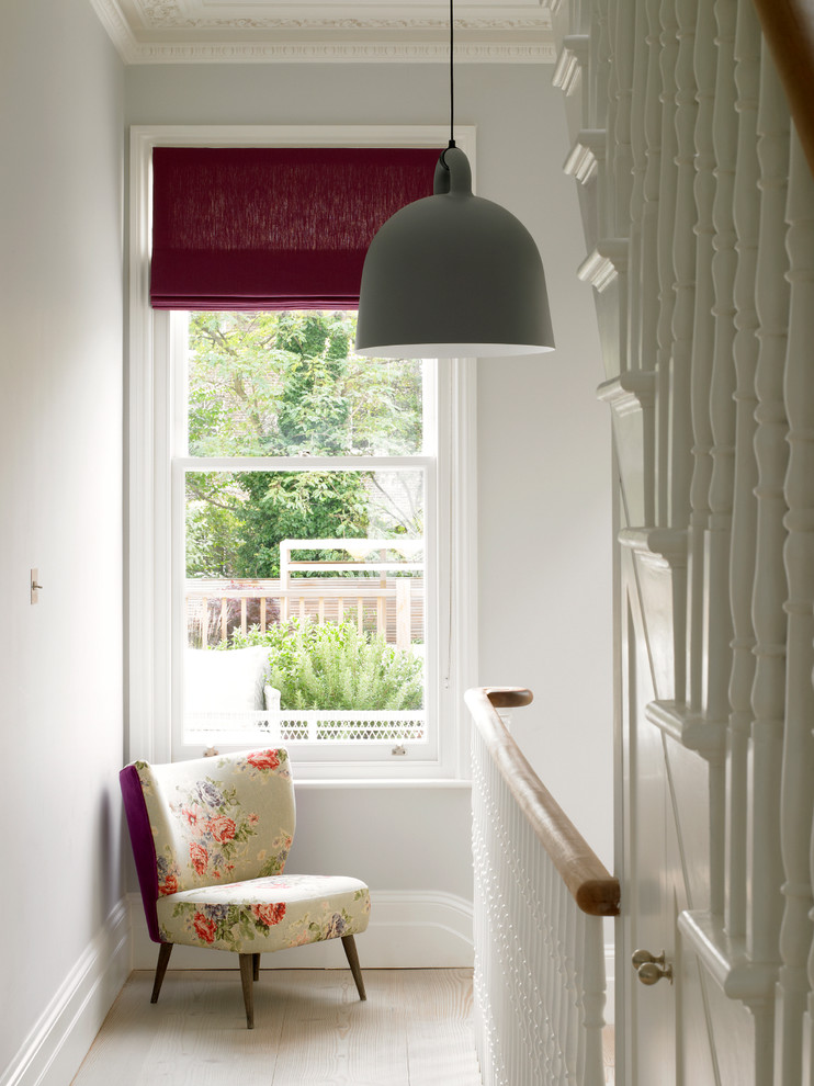 Inspiration for a mid-sized traditional hallway in London with grey walls, light hardwood floors and beige floor.