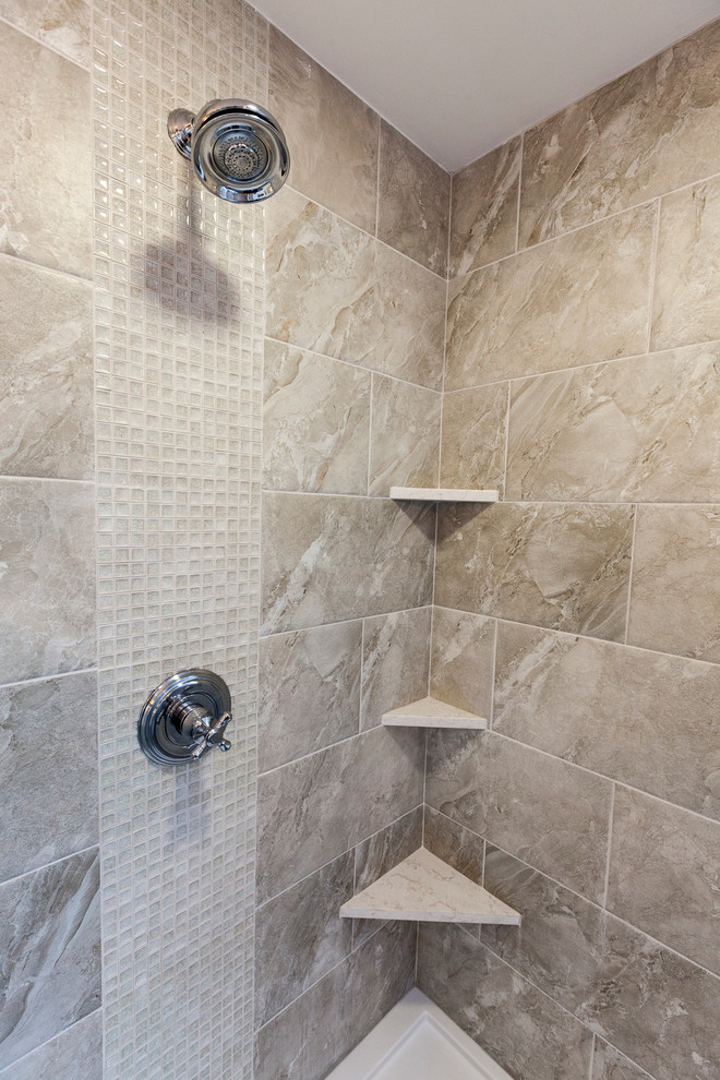 Example of a mid-sized transitional master gray tile and porcelain tile porcelain tile and gray floor freestanding bathtub design in New York with flat-panel cabinets, gray cabinets, a two-piece toilet, gray walls, an undermount sink, quartz countertops and a hinged shower door