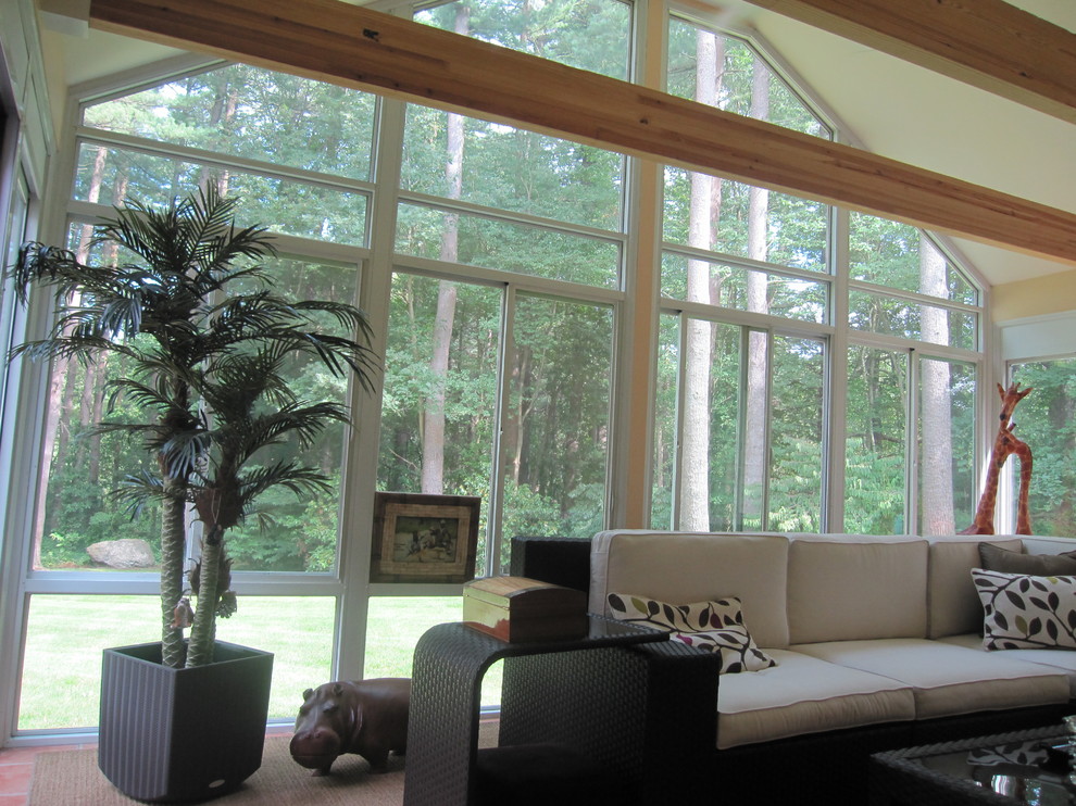 This is an example of a large traditional sunroom in Boston with terra-cotta floors and a standard ceiling.