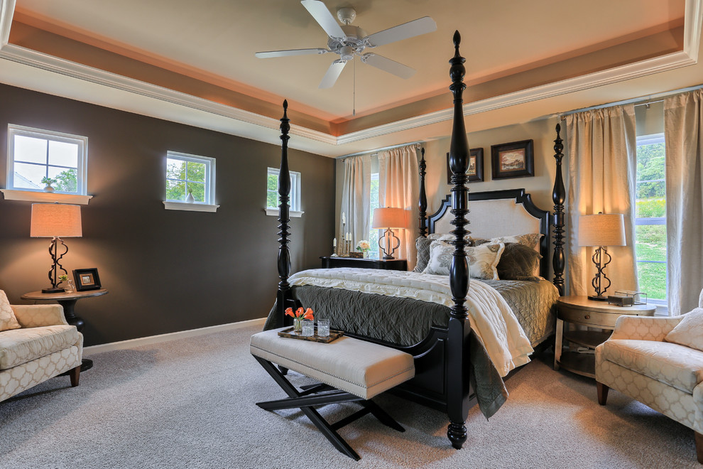 Inspiration for a large traditional master bedroom in Other with brown walls and carpet.