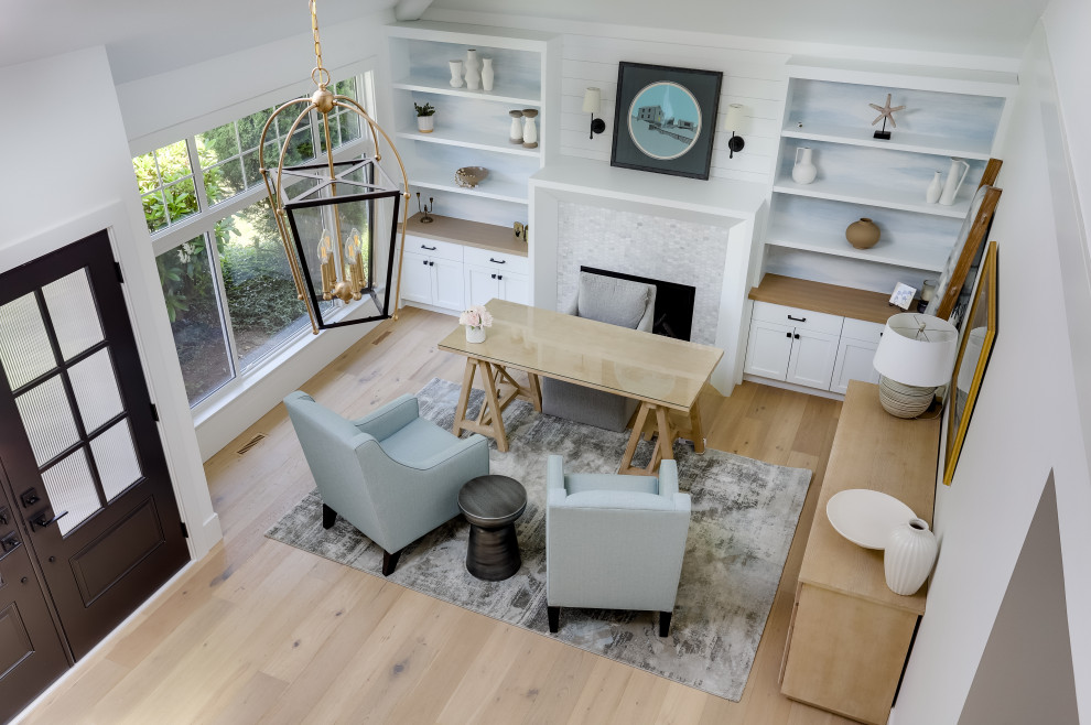 Inspiration for a mid-sized transitional home office in Vancouver with white walls, light hardwood floors, a standard fireplace, a tile fireplace surround, a freestanding desk, beige floor, vaulted and planked wall panelling.