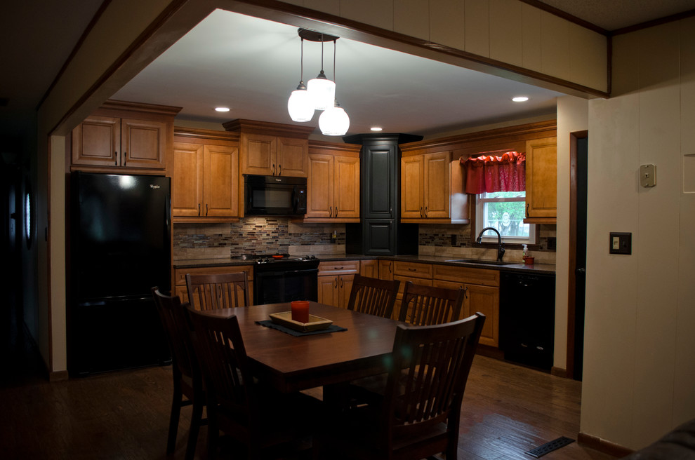Mid-sized mountain style l-shaped dark wood floor home design photo in Chicago with an undermount sink, raised-panel cabinets, medium tone wood cabinets, quartzite countertops, beige backsplash, glass tile backsplash, black appliances and no island