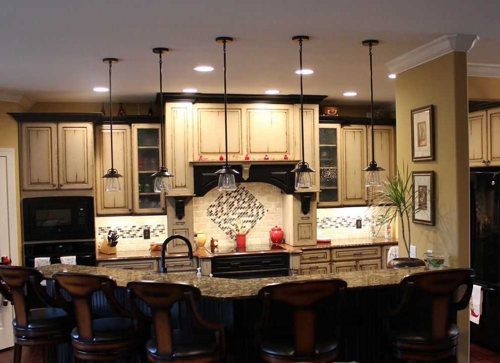 Photo of a country kitchen in St Louis with black cabinets and quartz benchtops.