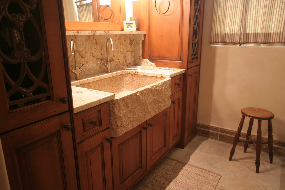 Photo of a mid-sized arts and crafts master bathroom in Denver with raised-panel cabinets, medium wood cabinets, beige tile, beige walls, an integrated sink, granite benchtops, a one-piece toilet and slate floors.