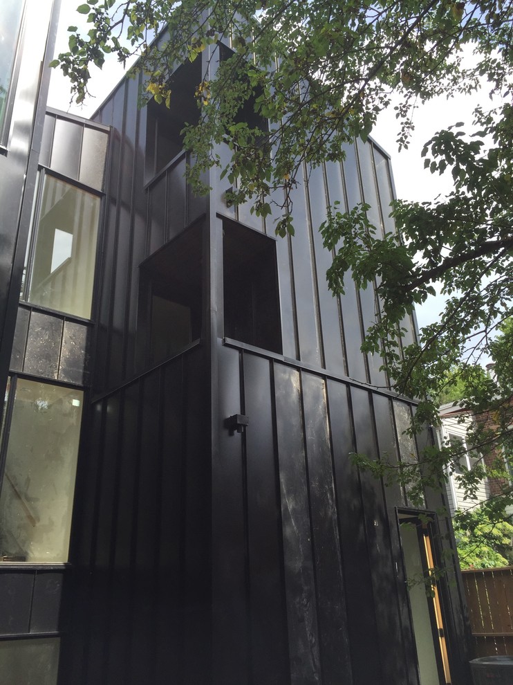 Photo of a contemporary black exterior in Toronto with metal siding.