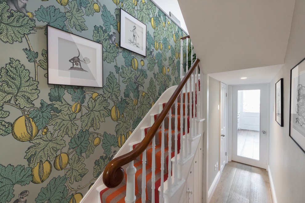 Inspiration for a large eclectic carpeted curved staircase in Other with wood risers, wood railing and wallpaper.