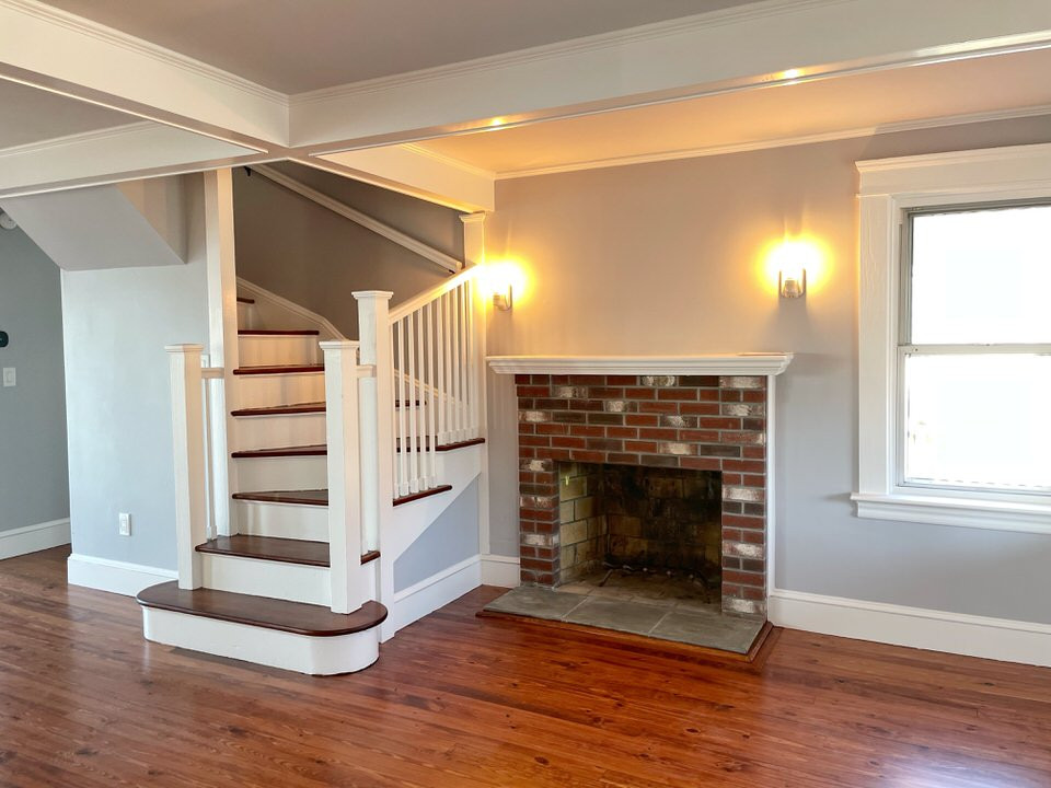 Inspiration for a small beach style open concept living room in Providence with brown walls, a standard fireplace, a brick fireplace surround, coffered and medium hardwood floors.