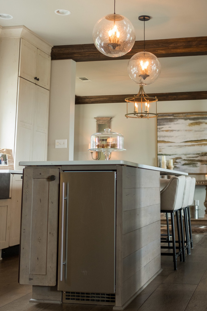 Example of a large transitional galley dark wood floor and brown floor open concept kitchen design with a farmhouse sink, shaker cabinets, quartz countertops, brown backsplash, brick backsplash, stainless steel appliances and an island