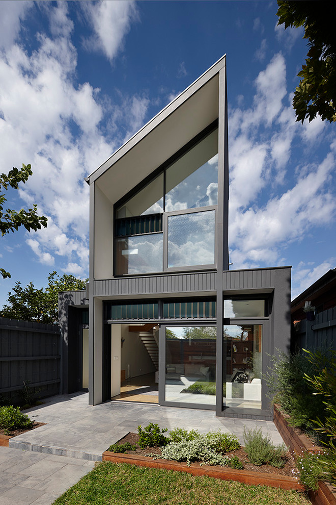 Mid-sized contemporary two-storey black exterior in Melbourne with mixed siding and a shed roof.