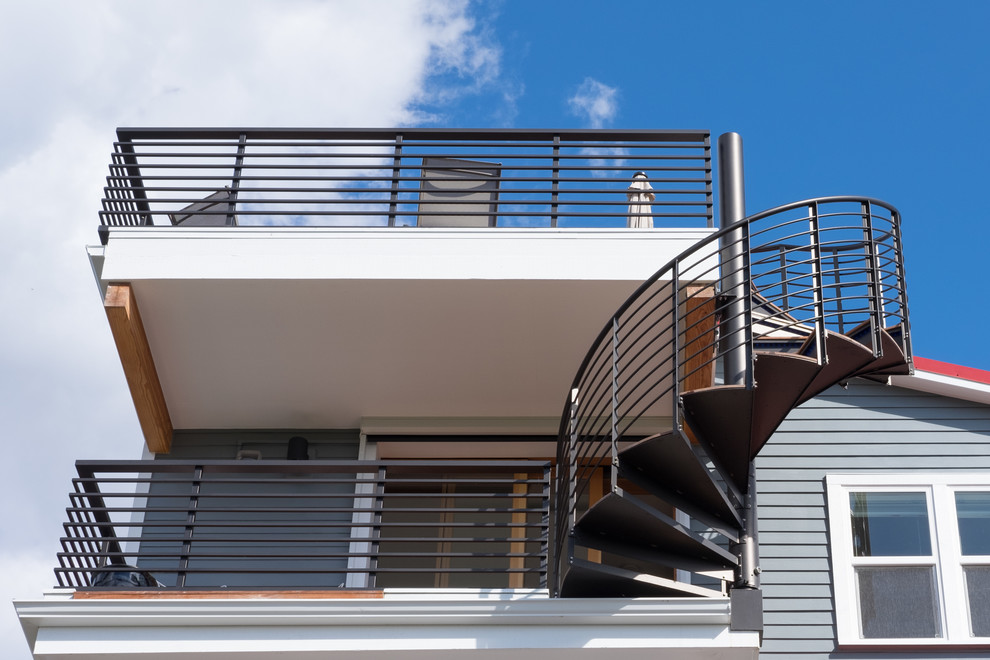This is an example of a mid-sized transitional metal spiral staircase in Seattle with open risers.
