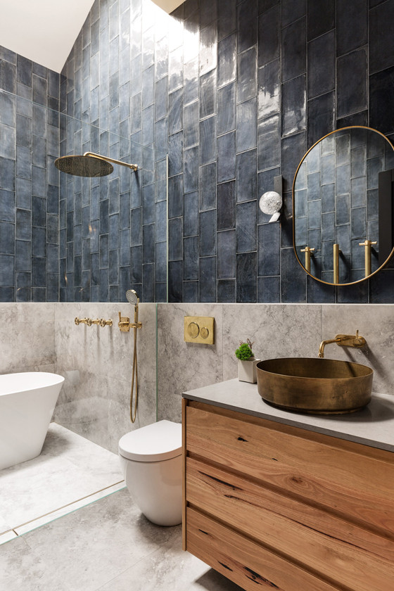 This is an example of an industrial bathroom in Sydney with blue tile and marble floors.