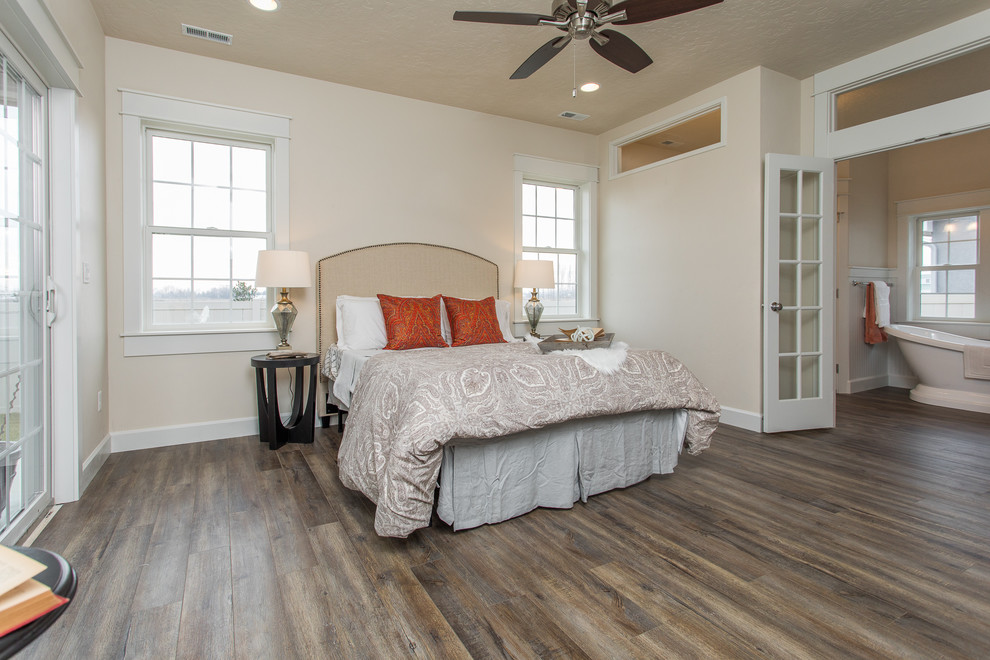 Photo of a mid-sized traditional master bedroom in Boise with beige walls, vinyl floors, no fireplace and grey floor.
