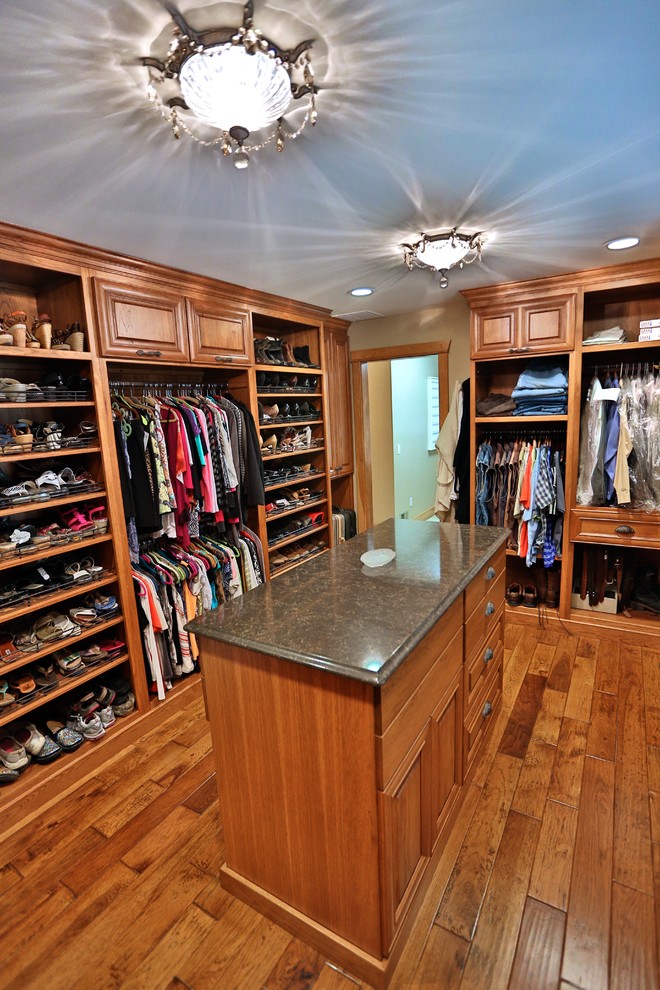 Design ideas for a large traditional gender-neutral walk-in wardrobe in Chicago with raised-panel cabinets, medium wood cabinets and medium hardwood floors.