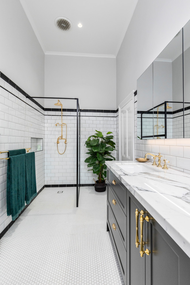 Photo of a large traditional master bathroom in Melbourne with recessed-panel cabinets, black cabinets, an open shower, white tile, subway tile, mosaic tile floors, an undermount sink, marble benchtops, an open shower, a freestanding tub, white floor, a niche, a single vanity and a freestanding vanity.
