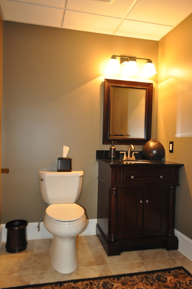 This is an example of a small traditional powder room in Philadelphia with brown walls and ceramic floors.