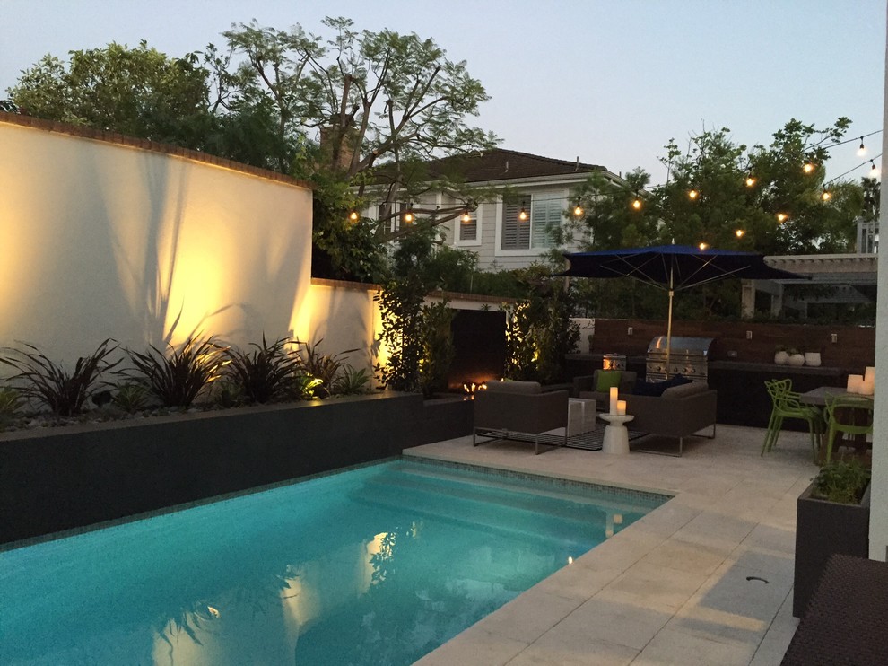 Design ideas for a mid-sized contemporary backyard rectangular lap pool in Los Angeles with tile.