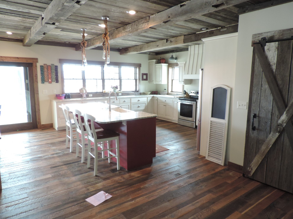 Eat-in kitchen - large rustic u-shaped dark wood floor eat-in kitchen idea with a farmhouse sink, raised-panel cabinets, white cabinets, marble countertops, stainless steel appliances and an island