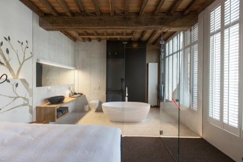Inspiration for a small eclectic master gray tile and ceramic tile freestanding bathtub remodel in Chicago with a vessel sink, open cabinets, light wood cabinets, wood countertops and a wall-mount toilet