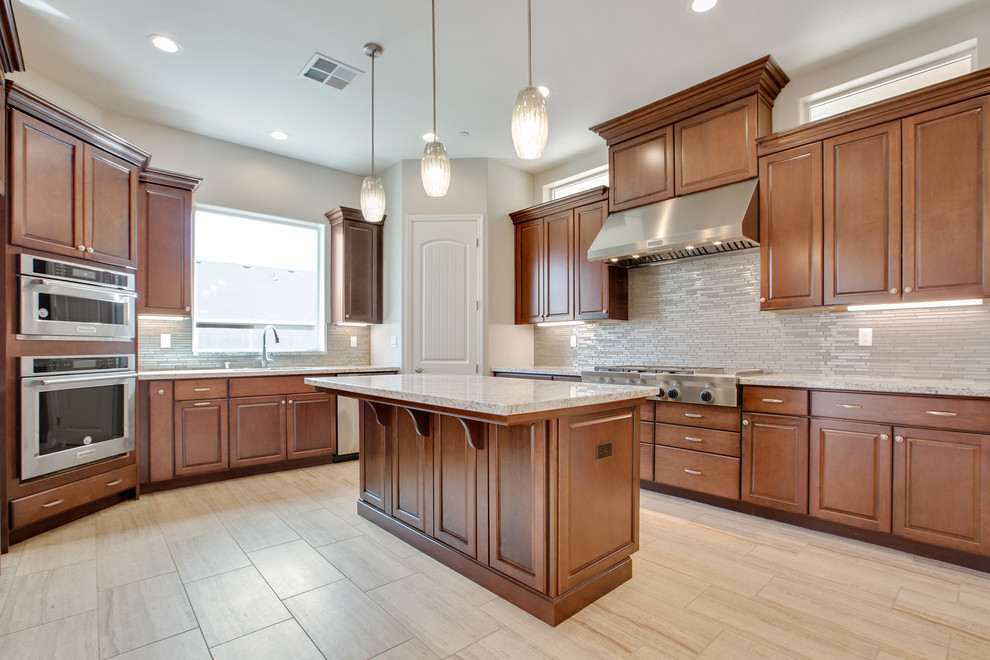 Inspiration for a large u-shaped kitchen pantry remodel with flat-panel cabinets, medium tone wood cabinets, gray backsplash, stainless steel appliances and an island