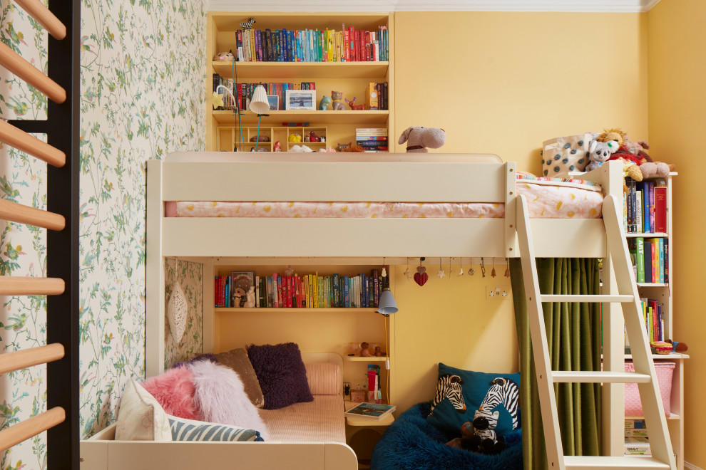 Eclectic children’s room in London with yellow walls and wallpapered walls.