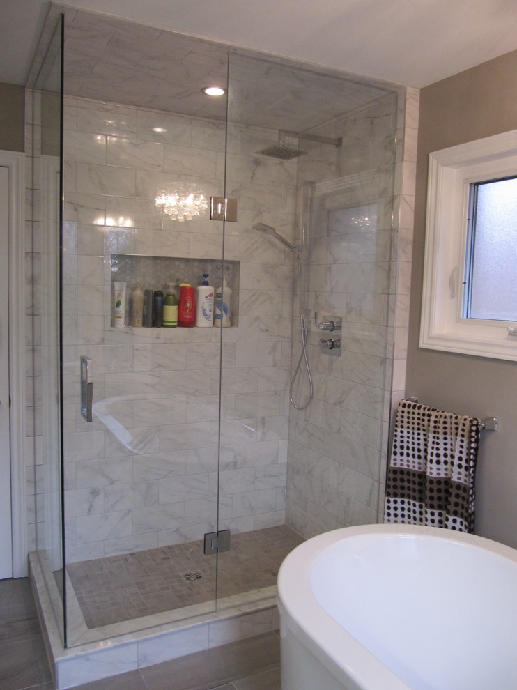 Large modern master bathroom in Toronto with furniture-like cabinets, a freestanding tub, a corner shower, gray tile, porcelain tile, grey walls, porcelain floors, grey floor and a hinged shower door.