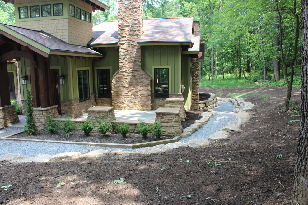 Inspiration for a rustic shade side yard retaining wall landscape.