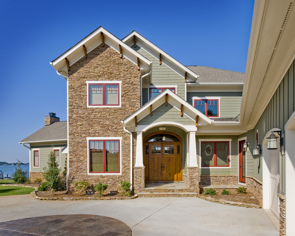 Photo of an arts and crafts exterior in Charlotte with stone veneer.