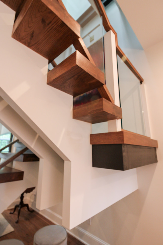 Inspiration for an expansive contemporary glass floating staircase in DC Metro with open risers and glass railing.