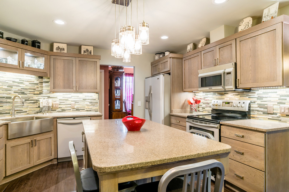 Enclosed kitchen - mid-sized transitional u-shaped medium tone wood floor enclosed kitchen idea in Miami with a farmhouse sink, shaker cabinets, gray cabinets, quartz countertops, gray backsplash, glass tile backsplash, white appliances and an island