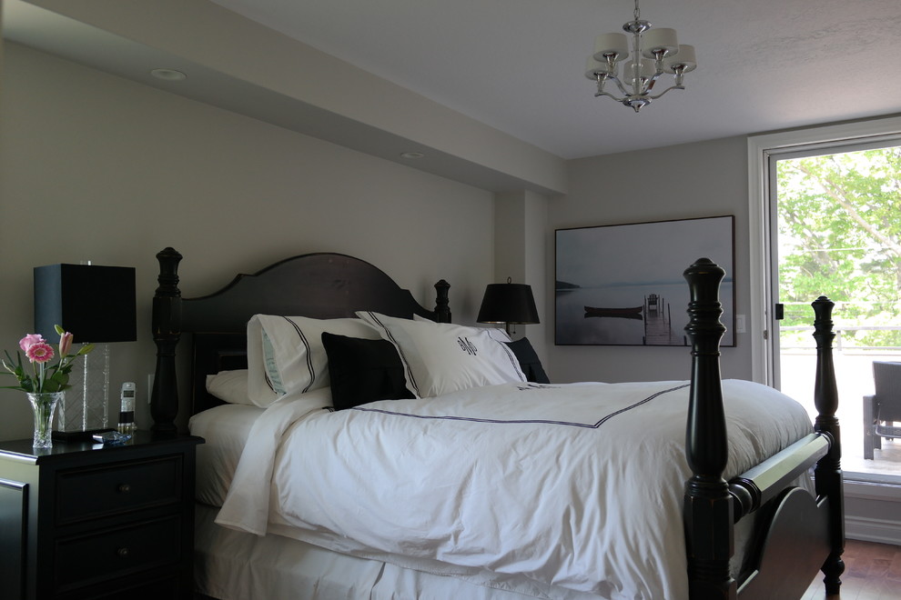 Inspiration for a mid-sized traditional master bedroom in Toronto with beige walls, medium hardwood floors, no fireplace and brown floor.