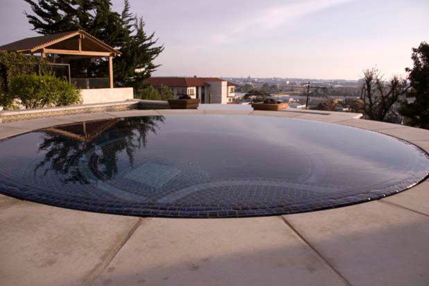 Large transitional backyard custom-shaped and stamped concrete natural hot tub photo in San Diego