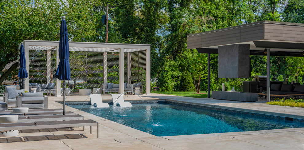 Design ideas for a contemporary backyard rectangular lap pool in Baltimore with a water feature.