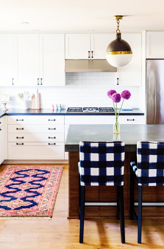 Photo of a mid-sized eclectic u-shaped eat-in kitchen in Portland with white cabinets, concrete benchtops, white splashback, subway tile splashback, stainless steel appliances, medium hardwood floors and with island.