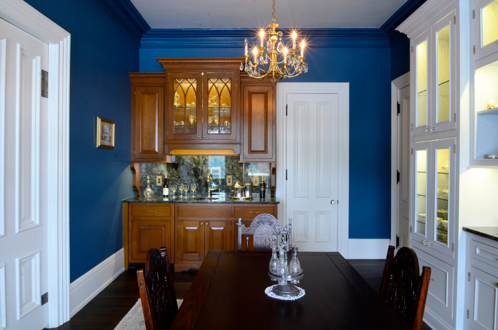 Design ideas for a traditional dining room in Milwaukee with blue walls and dark hardwood floors.
